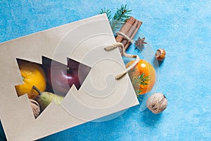 Christmas shopping for fruits, nuts and spices on blue background concept
