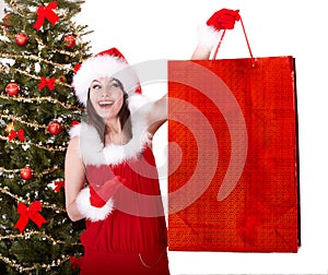 Christmas shopping of girl in santa hat, fir tree.