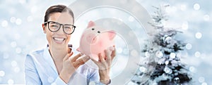 Christmas shopping, laughing fun woman with piggy bank isolated