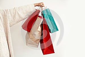 Christmas Shopping and seasonal sale. Happy Girl holding colorful shopping bags on white background isolated. Christmas Sales. Sp