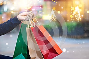 Christmas shopping-shopping bags in hand with snowflake