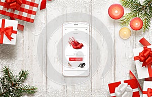 Christmas shopping with smart phone. Buying shoes online on commerce web site or app