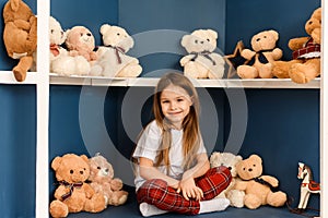 Christmas shopping in the toy store. Little cute girl with teddy bear