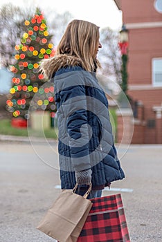 Christmas shopping woman holidng bags on sidewalk