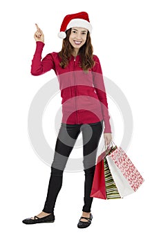 Christmas shopping woman pointing at copy space