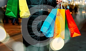 Christmas shopping of young beautiful woman. Colorful bright paper bags with gifts,presents.Walking on market street in city.