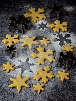 Christmas shortbread cookies in the form of snowflakes sprinkling sugar and cookie cutters. Xmas card concept.