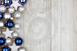 Christmas side border of blue and silver ornaments on gray wood