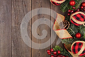 Christmas side border of red and black gingham ornaments on a dark wood background
