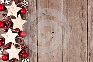 Christmas side border with rustic wood star ornaments and baubles on aged wood