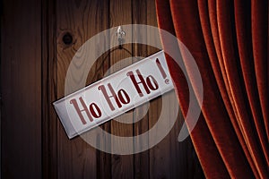 Christmas Sign HoHoHo Against Curtained Door