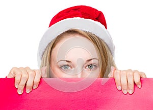 Christmas sign woman peeking over red board