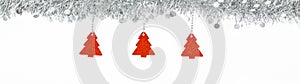 Christmas silver garland with red trees paper on white background. Banner panoramic