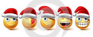 Christmas smiley vector set. Emoji xmas characters wearing santa red hat icon collection