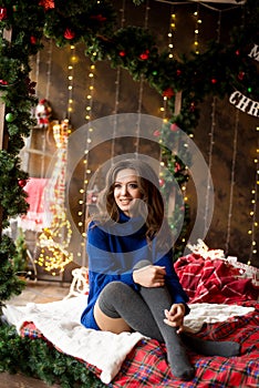 Christmas smiling woman model. Makeup. Healthy long hair style. lady over christmas tree lights background. happy new year