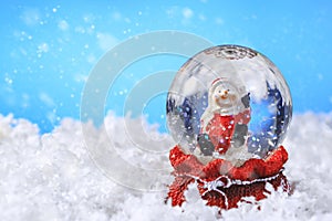 Christmas snow globe on blue background