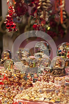 Christmas snow globes souvenirs on the advent market stall, close up