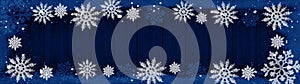 Christmas snow winter background banner panorama - Frame made of snow with snowflakes and ice crystals on blue wooden wood texture