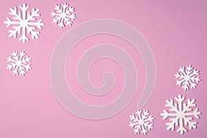 Christmas snowflake border frame on pink background. Christmas minimal texture with copy space. top view