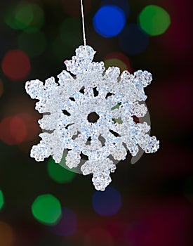 Christmas snowflake ornament with defocused lights
