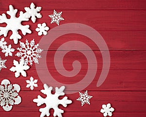 Christmas Snowflakes Decorations on the Side of  Rustic Red Wood Boards Background with looking-down view in a Horizontal crop tha photo