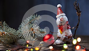 Christmas snowman decoration against the backdrop illumination and fir tree