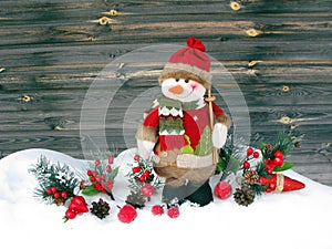 Christmas snowman decoration winter berries and snow on wooden b