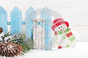 Christmas snowman and sledge toys and fir tree branch
