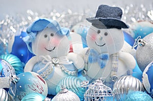 Christmas snowmen surrounded by New Year`s toys