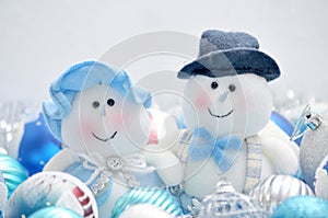 Christmas snowmen surrounded by New Year`s toys