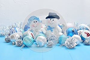 Christmas snowmen surrounded by New Year`s toys