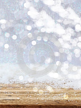 Christmas snowy bokeh background. Snowfall over a wooden table, xmas card template
