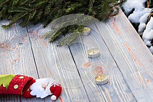 Christmas sock on wooden background. Toy and Christmas stocking, there is a branch of fir. Christmas and New Year decorations.