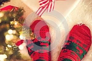 Christmas socks and gift box on a white carpet