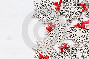 Christmas soft beige wooden snowflakes on a wood white background.