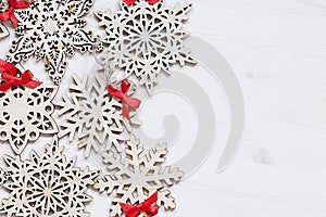 Christmas soft beige wooden snowflakes on a wood white background.