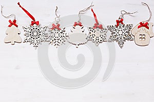 Christmas soft beige wooden snowflakes on a wood white background.