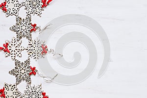 Christmas soft beige wooden snowflakes on a wood white background.