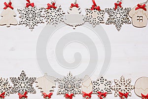 Christmas soft beige wooden snowflakes on a wood white background.