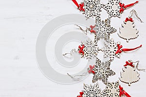 Christmas soft beige wooden snowflakes on a wood white background.