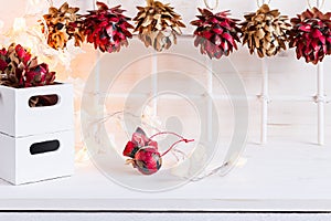 Christmas soft home craft decorations and burning lights on a wood white background.