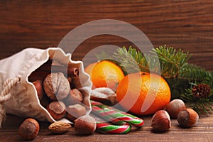 Christmas spirit: nuts, tangerines, Christmas tree, nuts, a flashligh