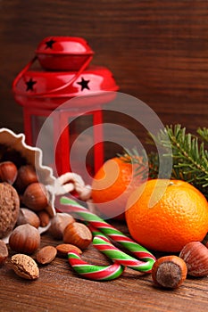 Christmas spirit: nuts, tangerines, Christmas tree, nuts, a flashlight