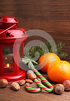 Christmas spirit: nuts, tangerines, Christmas tree, nuts, a flashlight