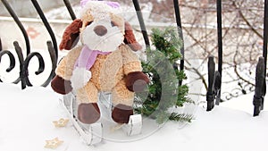 Christmas spirit. A soft toy on a sleigh. Christmas decorations in the snow