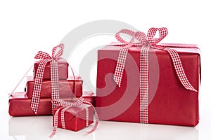 Christmas: stack of red gift boxes with bow and ribbon, isolated