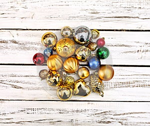 Christmas stack of Xmas balls decorations on white wooden boards