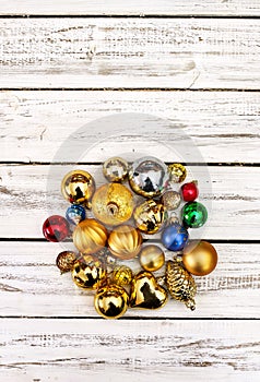 Christmas stack of Xmas balls decorations on white wooden boards