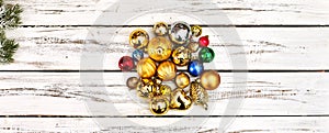 Christmas stack of Xmas balls decorations on white wooden boards