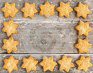 Christmas Star Cookies as Background on Brown Wood
